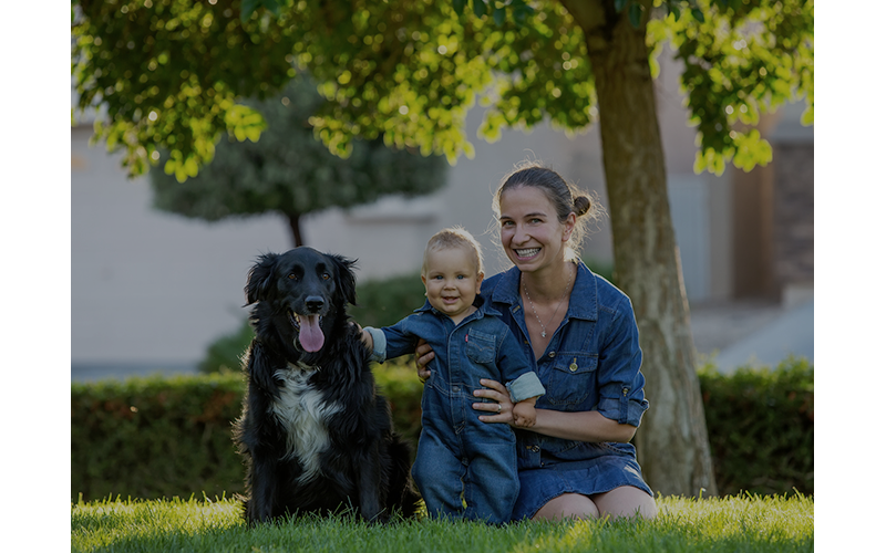 Woman, child, and dog smiling