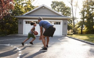 Father and daughter playing basketball.